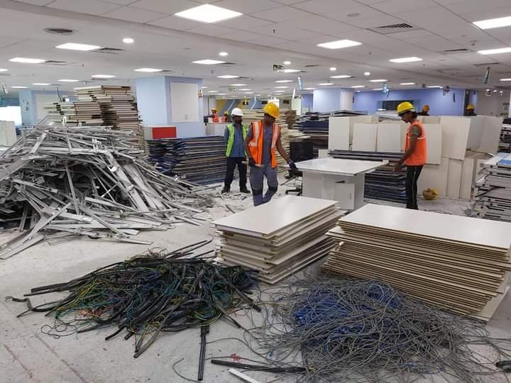 Team clearing cabling and furniture during an office dismantling project